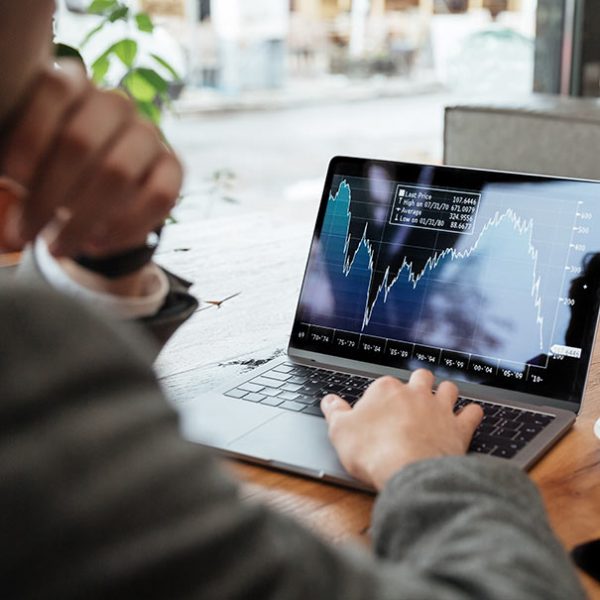 A person sitting at a table with a laptop.